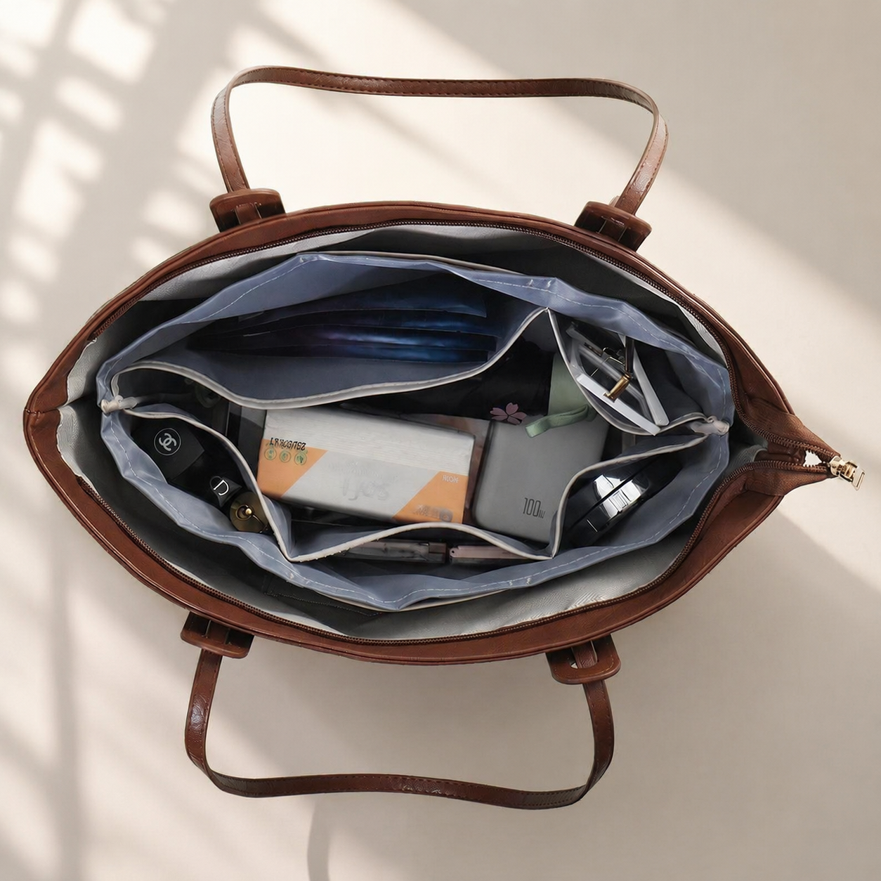 Purse organizer insert arranged inside a tote bag with everyday essentials
