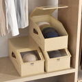 Foldable baseball cap storage boxes on a closet shelf with one open