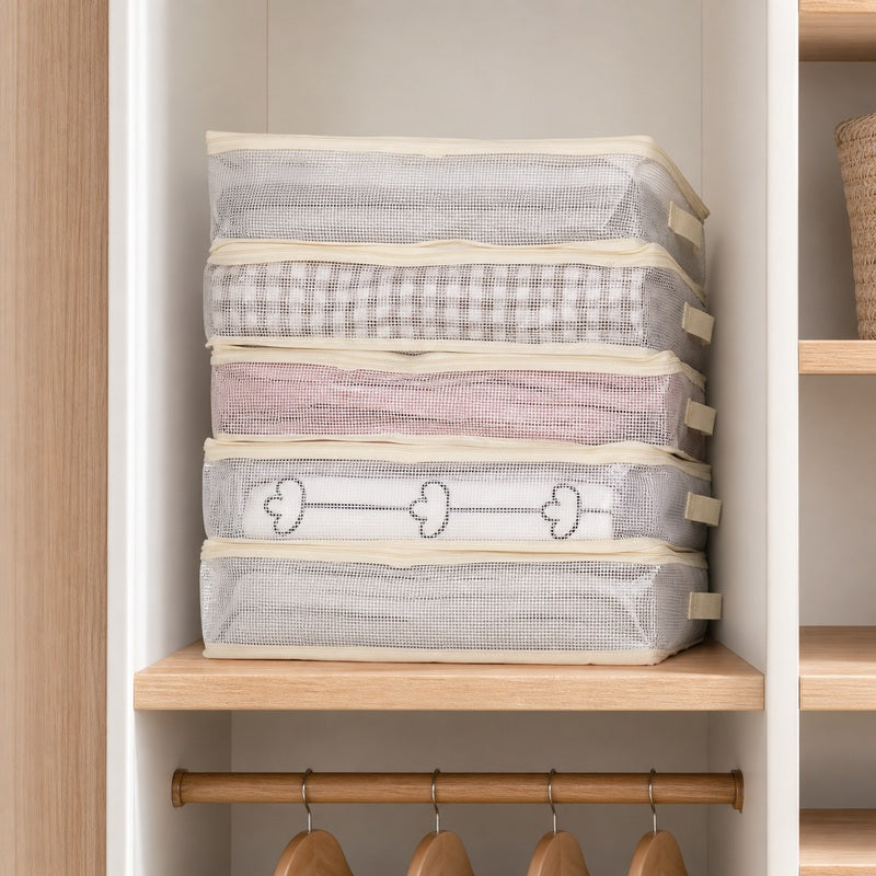 Stacked clear foldable bedding storage bags in a bright closet
