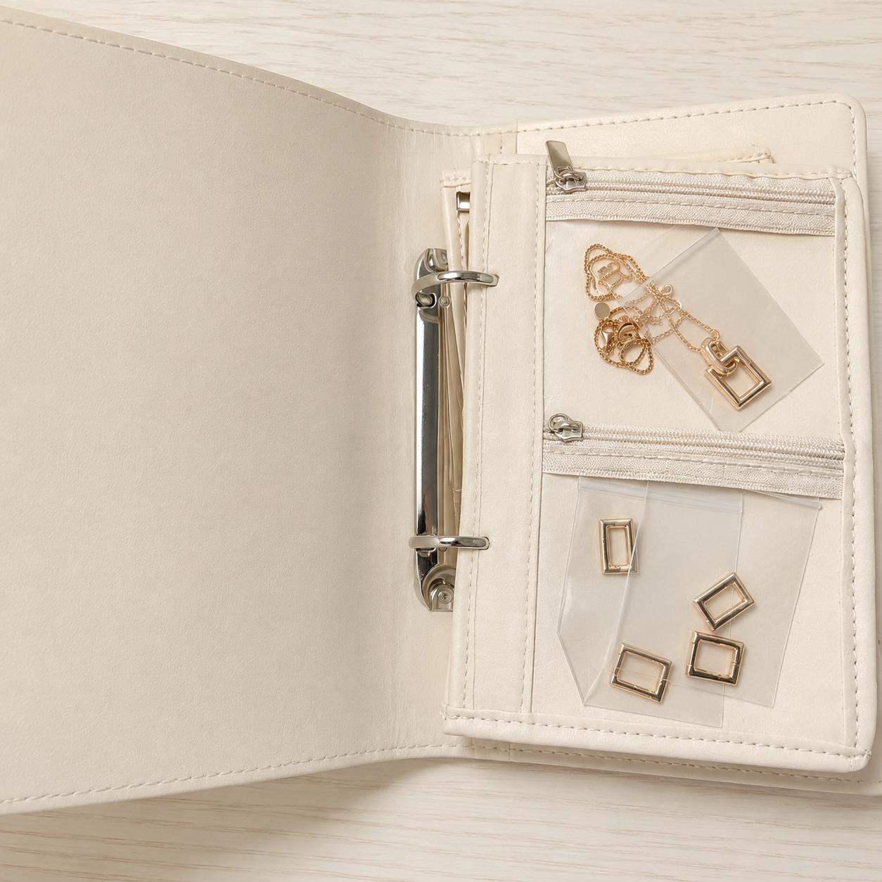 Clear pouch page detail for earrings and small accessories inside the travel jewelry organizer book