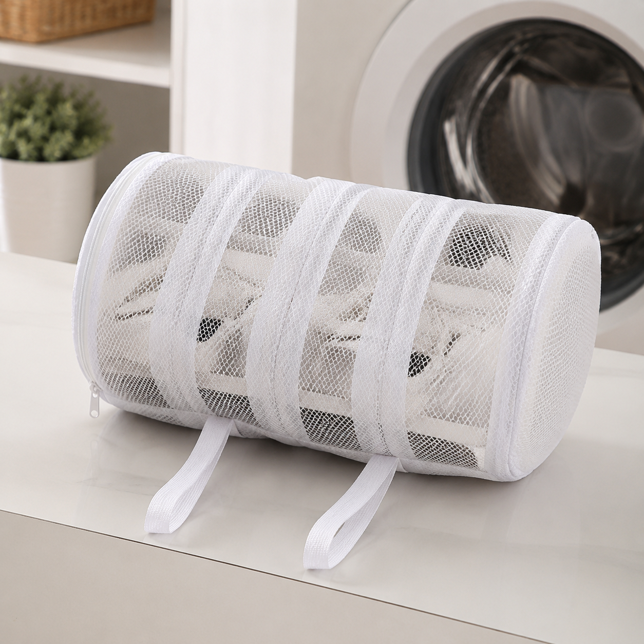White cylindrical mesh shoe washing bag detail
