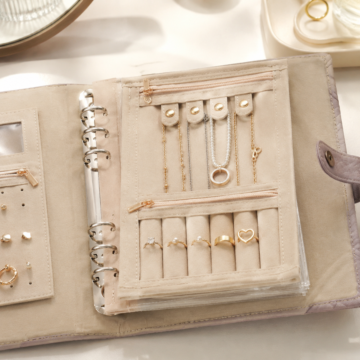 Open jewelry organizer book detail with ring strips pockets and necklace holders