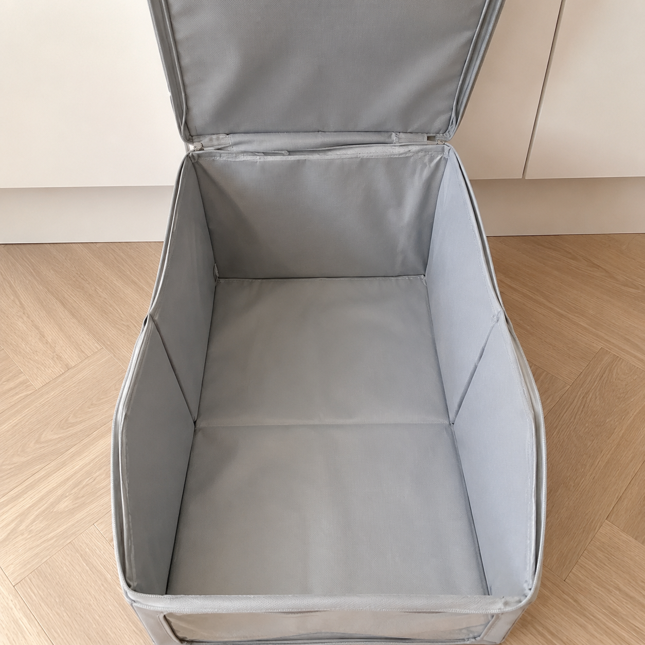 Open empty interior detail showing foldable side panels and storage depth